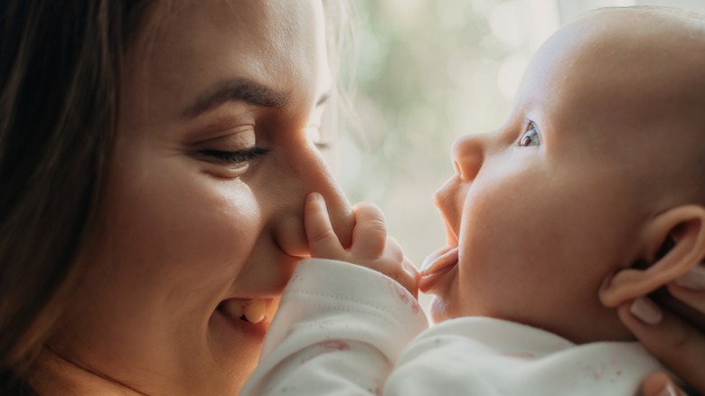 Mother playing with baby