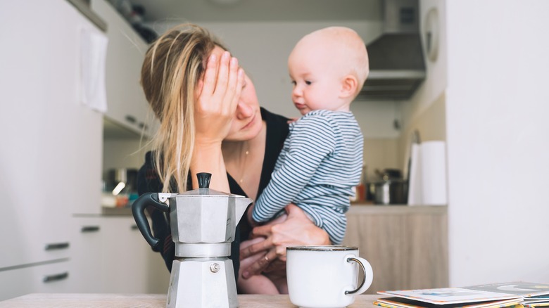 Tired mother with child