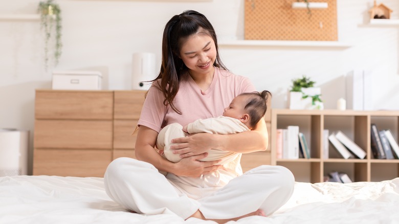 Mother smiling at newborn