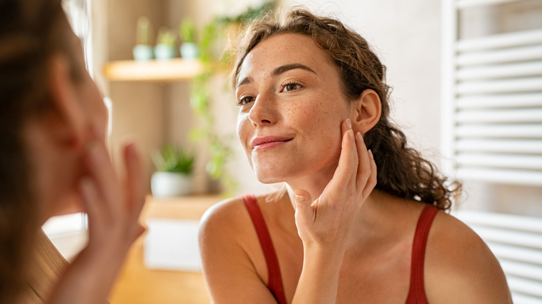 Woman admiring skin 