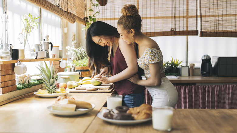 Couple laughing in the kitchen