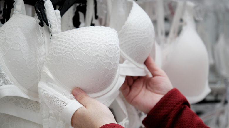 white underwire bras hanging in store