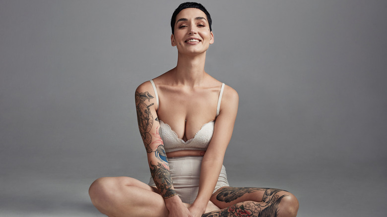 Woman with tattoos sitting 