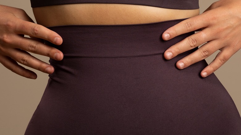 Woman wearing shapewear with her hands on her hips