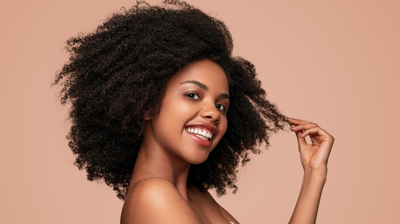 Black woman touching her natural hair