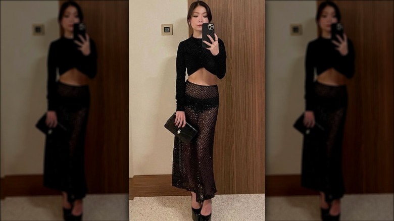 woman taking mirror selfie in monochromatic outfit