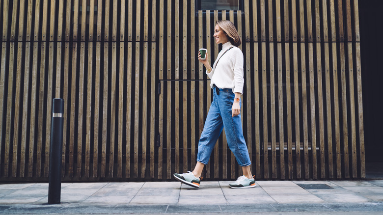 woman walking down a city street in comfortable footwear 