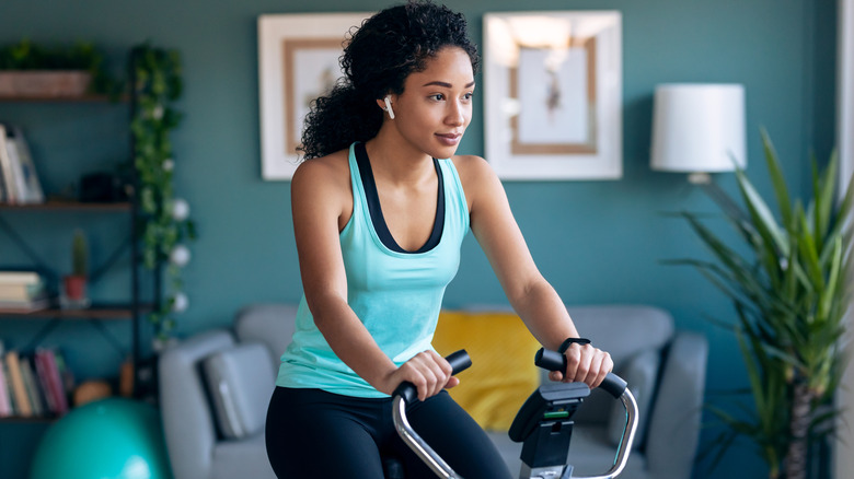 Woman smiling on stationary bike 