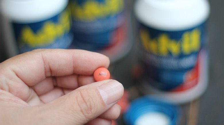 Person holding Advil pill