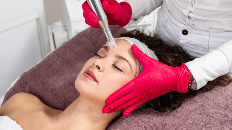 Young woman getting microneedling done 