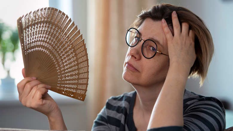 Woman fanning herself