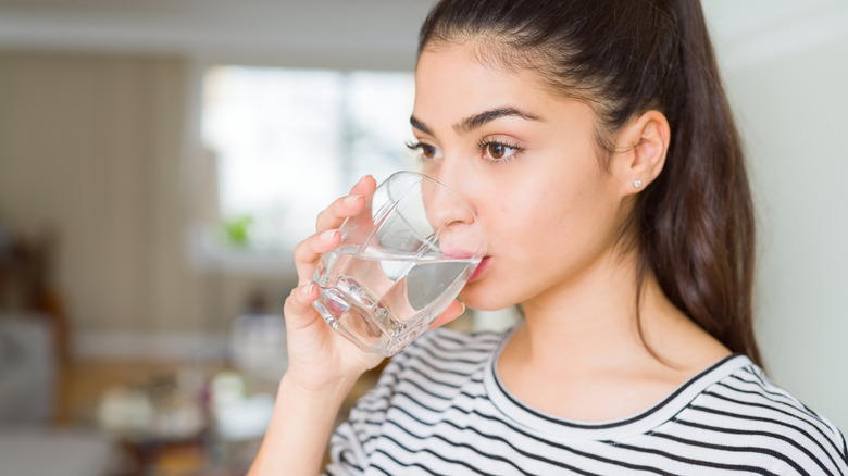 a woman drinking water 