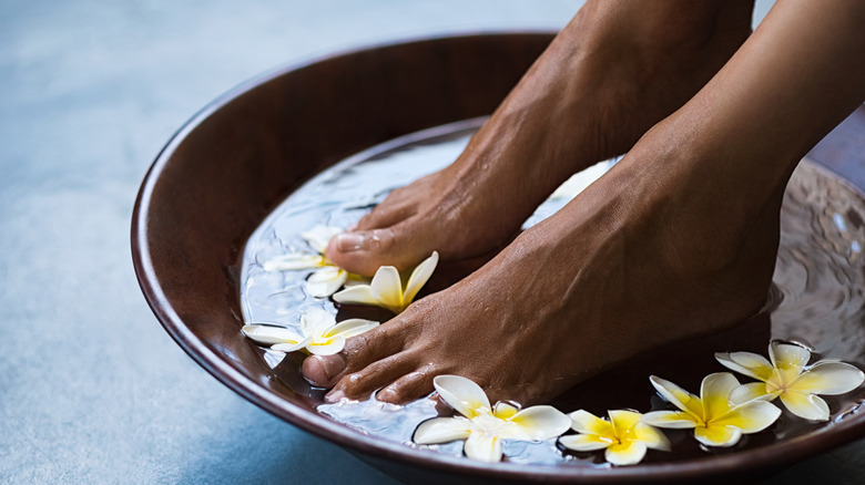 Woman prepping feet for pedicure
