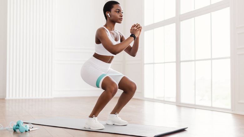 woman exercising on mat