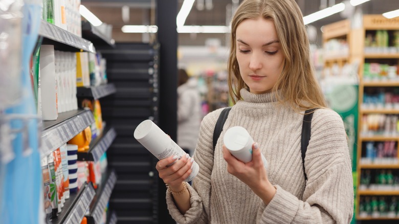 woman choosing hair products at store