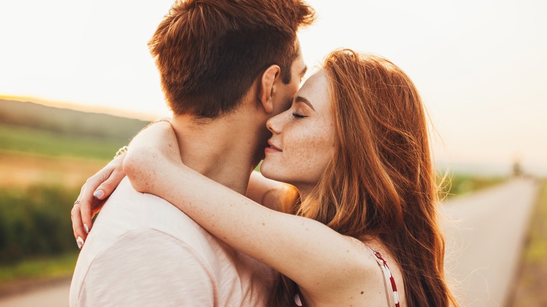 A man and a woman embracing. 