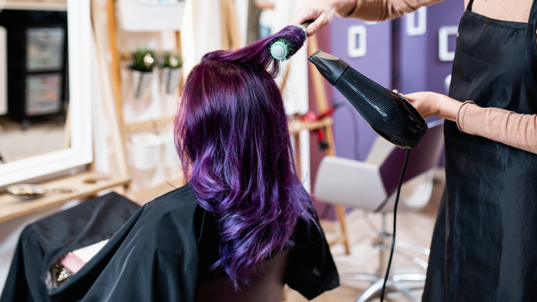 purple haired woman at stylist