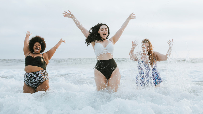 Women of different body types enjoying the beach