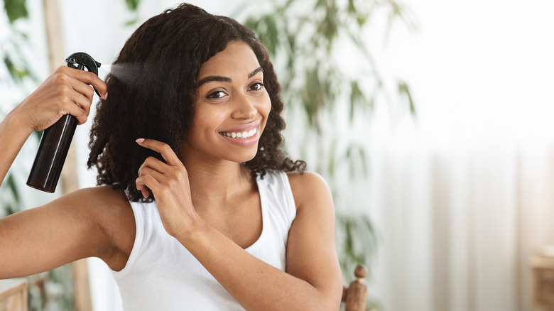 Woman spraying hair product