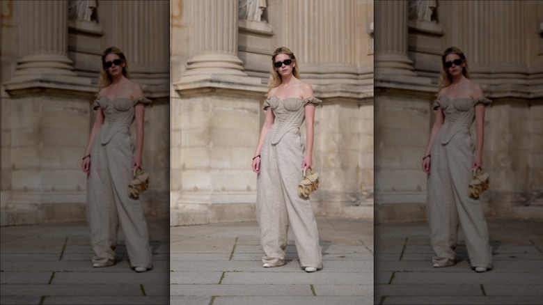 Woman in beige corset, pants