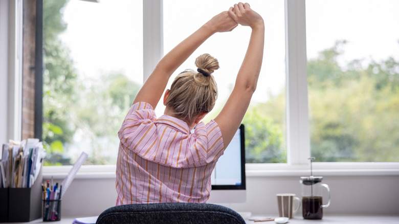 Stretches in front of the computer