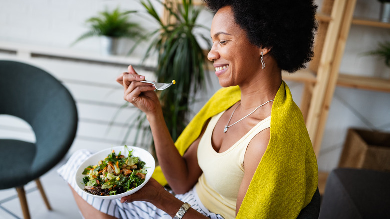 A woman holding food in her hands. 