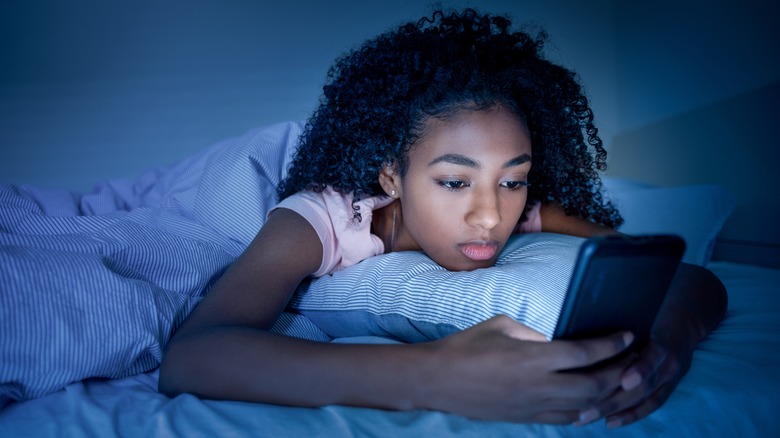 A woman laying awake in her bed. 