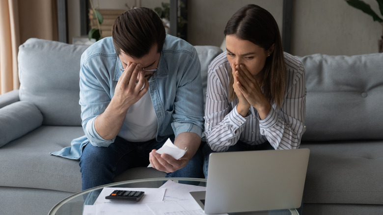 stressed couple in front of computer