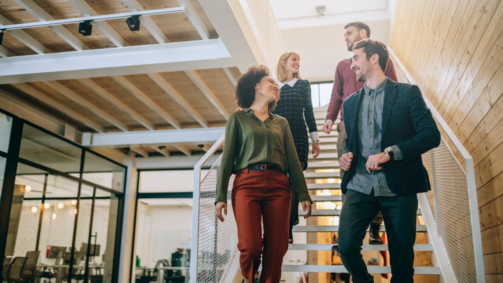 Coworkers coming down the stairs together