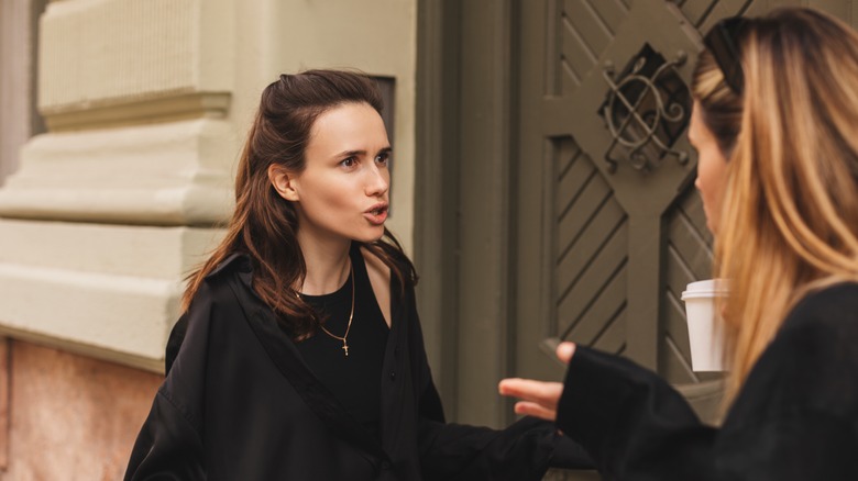 friends arguing in the street