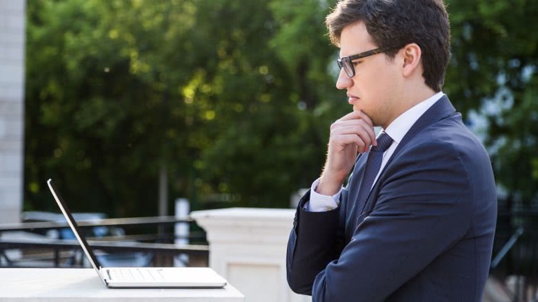 man looking at computer unhappy