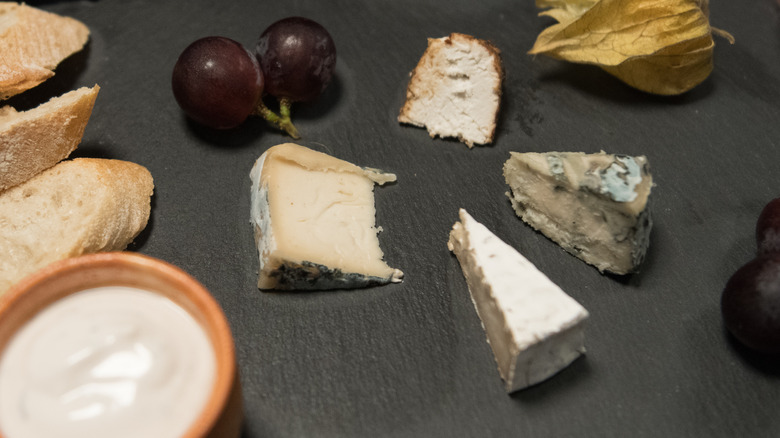 vegan cheeses on black platter