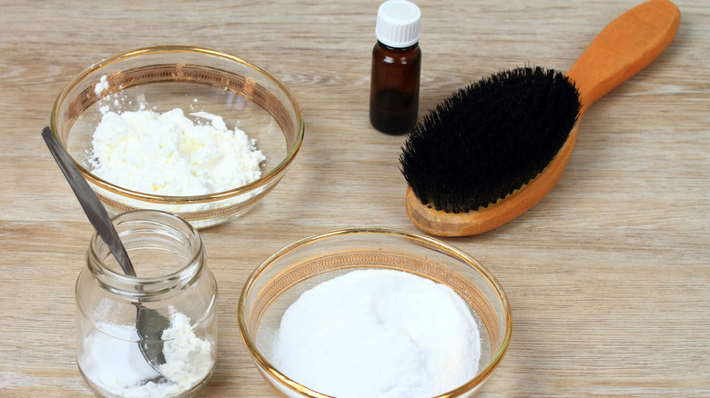 A hairbrush alongside natural hair treatments.