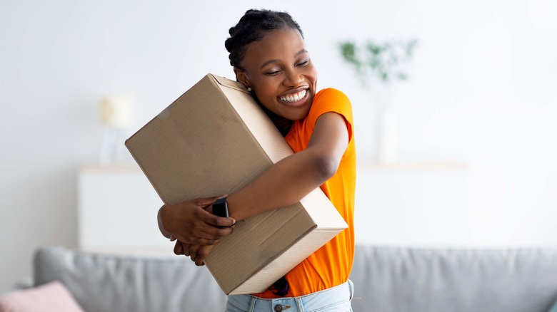 Woman hugging a box