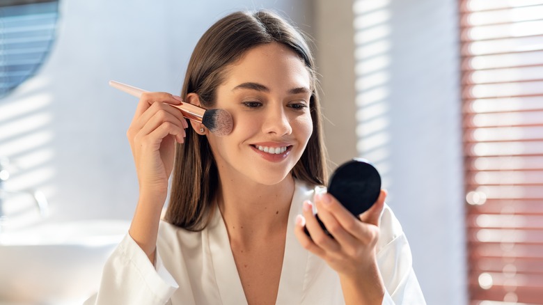 Woman applying makeup