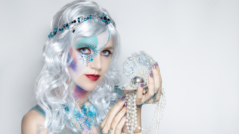 Woman in a mermaid costume with a silver wig