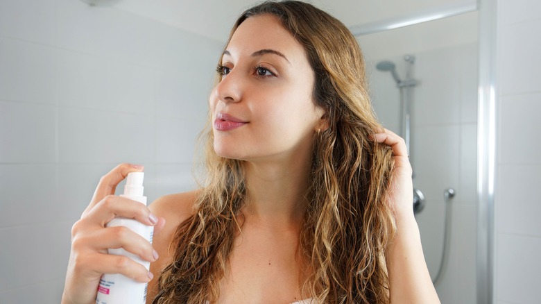 woman applying heat protectant