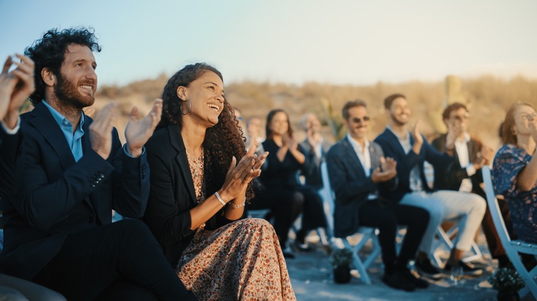 wedding guests clap at ceremony 