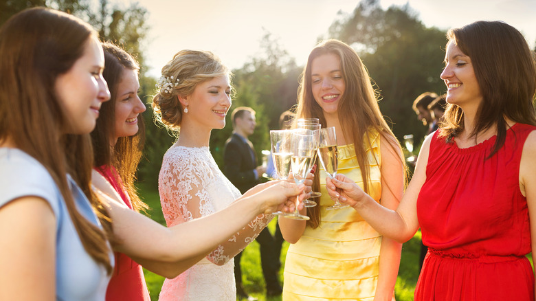 women clinking glasses with a bride