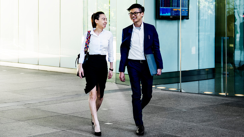 coworking couple walking outside of office