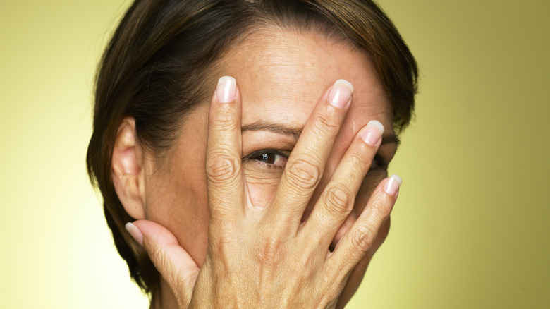 Woman hiding her face 