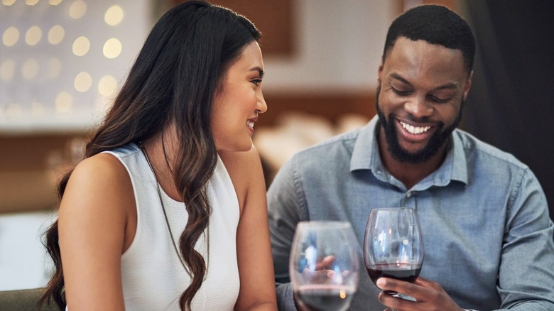 smiling couple drinking wine