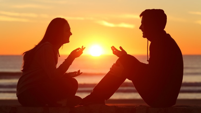 Couple talking during sunset