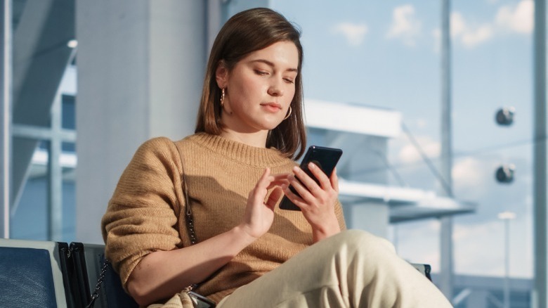 Woman scrolling through phone