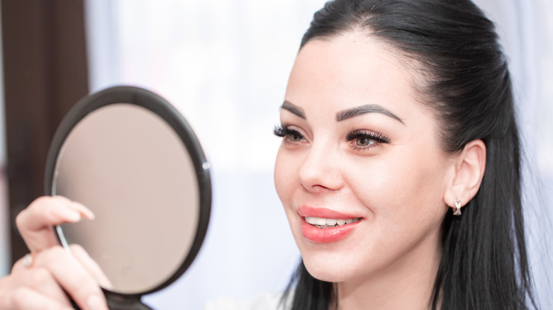 Woman looking in mirror 