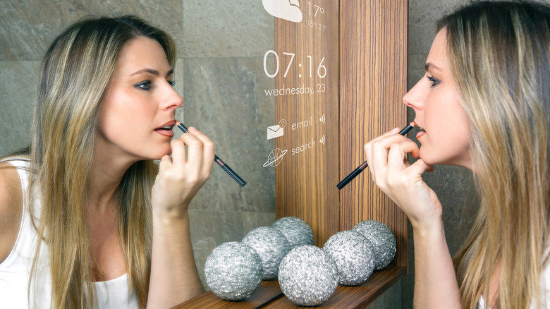 Woman applying lip liner 