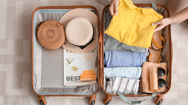 Woman packing suitcase