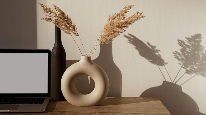 vase on desk with dried grasses