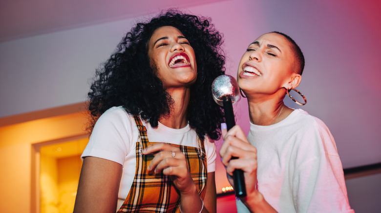 two friends singing karaoke