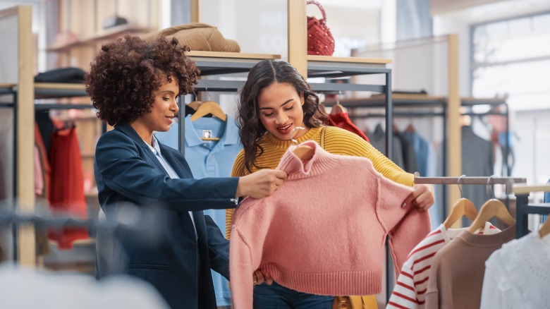 Young woman shopping for clothes in a retail store